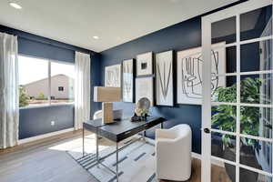 Office featuring wood finished floors and recessed lighting