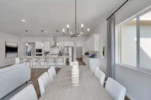 Dining room featuring a chandelier, light wood-type flooring, and recessed lighting