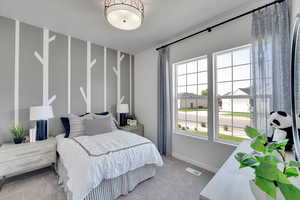 Carpeted bedroom with baseboards