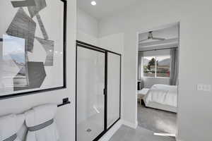 Full bath featuring connected bathroom, a stall shower, light tile patterned floors, ceiling fan, and a mountain view