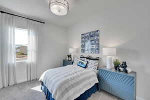 Carpeted bedroom featuring baseboards