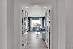 Interior space featuring french doors, a textured ceiling, light wood-type flooring, and recessed lighting