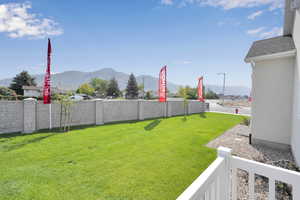 View of green lawn featuring a mountain view
