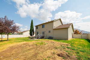 Back of property featuring a fenced backyard, a gate, and a mountain view