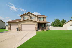 Craftsman-style home featuring covered porch, concrete driveway, a garage, and stone siding