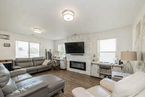 Living area with a fireplace and wood finished floors