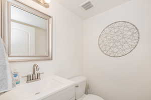 Bathroom featuring vanity and toilet