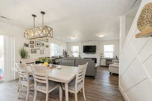 Dining room with wood finished floors and a fireplace