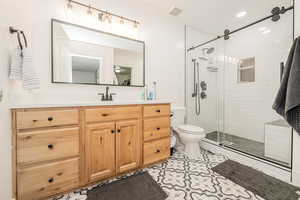 Full bathroom with vanity, a shower stall, light tile patterned flooring, and recessed lighting