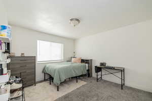 Bedroom with light carpet and baseboards