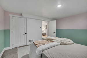 Bedroom with carpet flooring and a textured ceiling