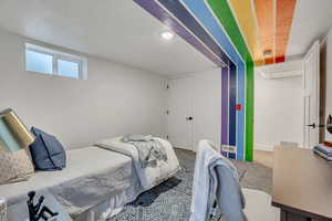 Bedroom featuring carpet and baseboards