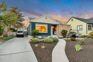 View of front of house with brick siding and concrete driveway