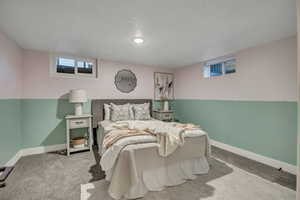 Bedroom with baseboards and carpet