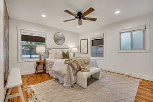 Bedroom featuring multiple windows, a ceiling fan, recessed lighting, and light wood-style flooring