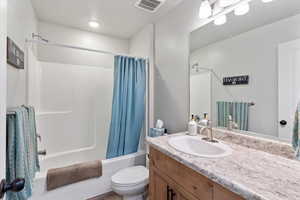 Bathroom featuring shower / tub combo and vanity