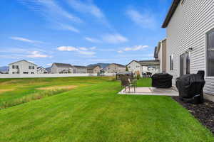 View of yard featuring a patio and a residential view