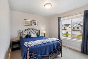 Bedroom featuring carpet flooring and baseboards