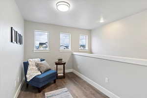 Living area with wood finished floors and baseboards