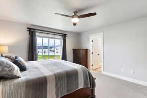 Carpeted bedroom with a ceiling fan and ensuite bathroom