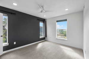 Upstairs bedroom with new carpet, a ceiling fan, and recessed lighting, with mountain views