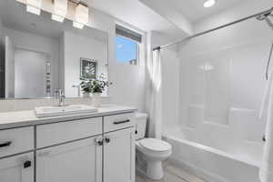 Upstairs full bathroom with shower / tub combo with curtain and vanity