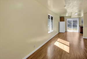 Spare room with dark wood finished floors and a textured ceiling