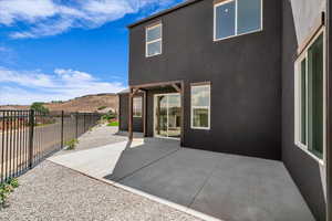 Rear view of house with a patio area and stucco siding