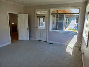 Empty room with carpet and ornamental molding