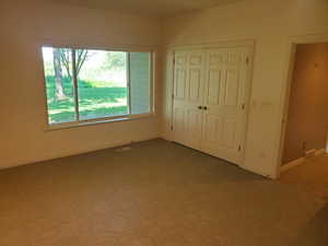 Unfurnished bedroom with carpet and a closet
