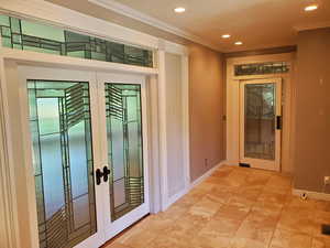 Hallway featuring french doors, recessed lighting, ornamental molding, and tile patterned floors