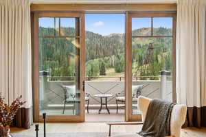 Entryway featuring a view of trees, wood finished floors, and a mountain view