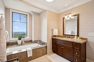 Bathroom featuring a garden tub, vanity, light tile patterned floors, ornamental molding, and recessed lighting