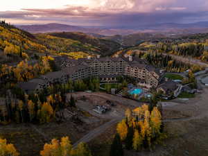 Aerial view of property and surrounding area featuring a pool and a mountain backdrop