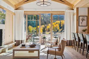 Sitting room featuring wood finished floors and a fireplace with raised hearth