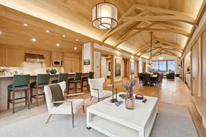 Building lobby with a wooden ceiling with exposed beams, high vaulted ceiling, and recessed lighting