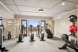 Workout area featuring ornamental molding, recessed lighting, and a paneled ceiling