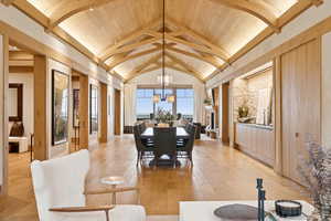 Dining space with light wood-style flooring and wood ceiling