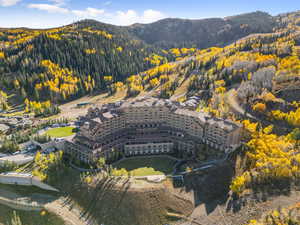 Aerial view of property and surrounding area with a mountainous background