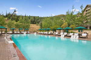 Community pool with a patio