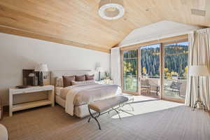 Carpeted bedroom with wooden ceiling, vaulted ceiling, and access to outside