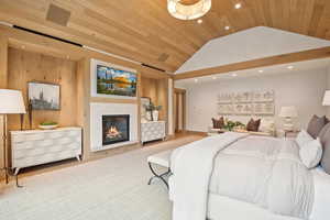 Bedroom featuring recessed lighting, lofted ceiling, a tiled fireplace, wood ceiling, and wood finished floors