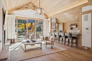 Living area with wooden ceiling, lofted ceiling, light wood-style flooring, and recessed lighting