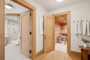 Hallway with a sauna and wood finished floors