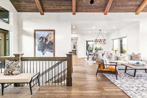 Living area featuring light wood finished floors, recessed lighting, a chandelier, and wood ceiling