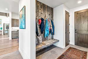 Mudroom with recessed lighting and light tile patterned flooring