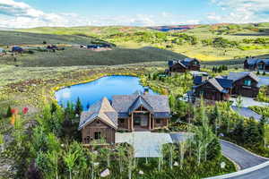Aerial view of property and surrounding area with a nearby body of water