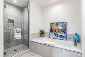 Bathroom with a stall shower, a bath, tile patterned floors, and recessed lighting