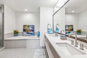 Bathroom featuring double vanity, a garden tub, a shower stall, light tile patterned floors, and recessed lighting