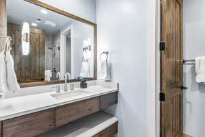 Bathroom featuring vanity and a tile shower